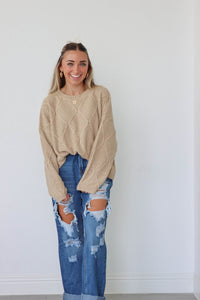 girl wearing tan knit sweater