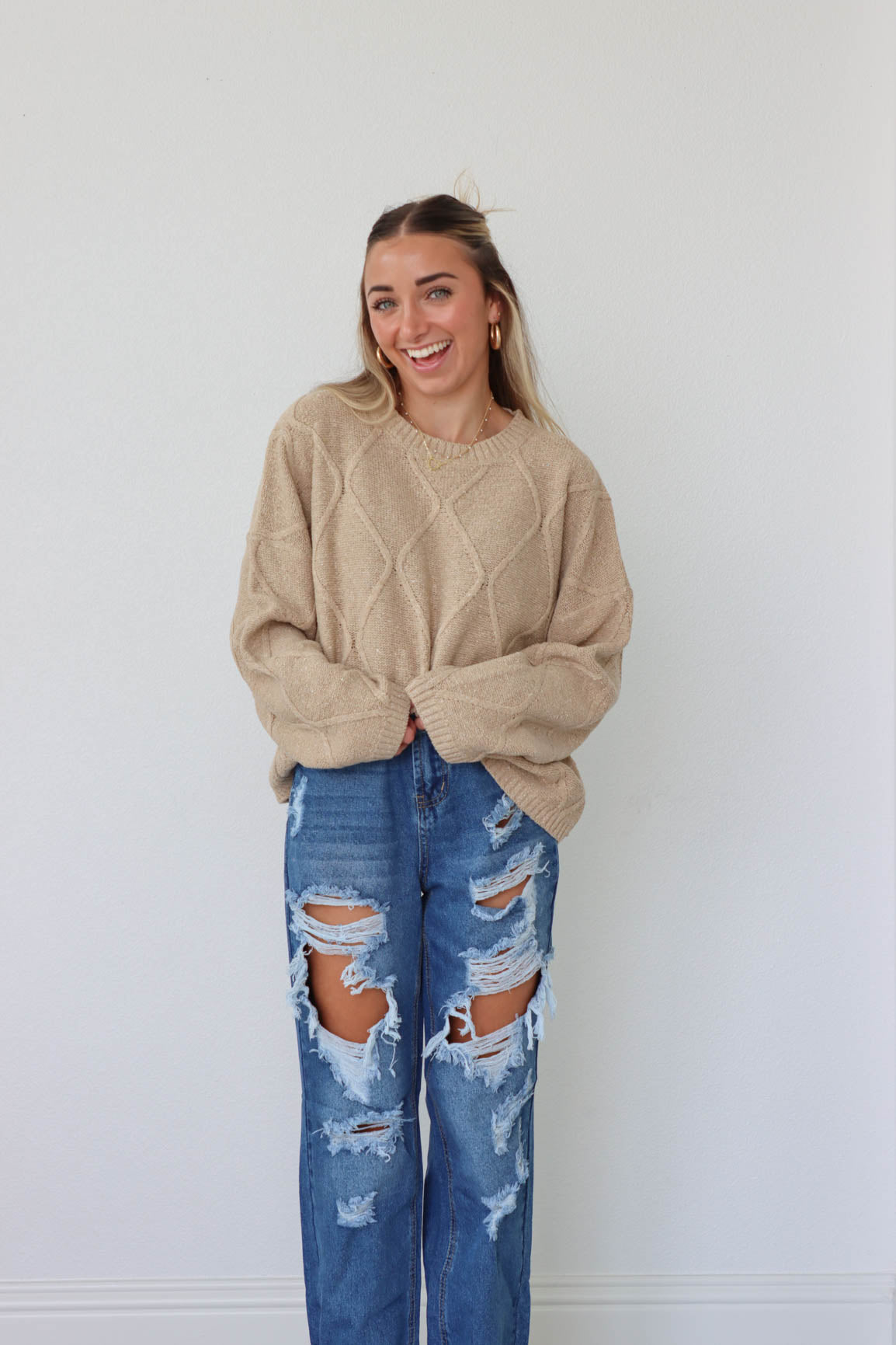 girl wearing tan knit sweater