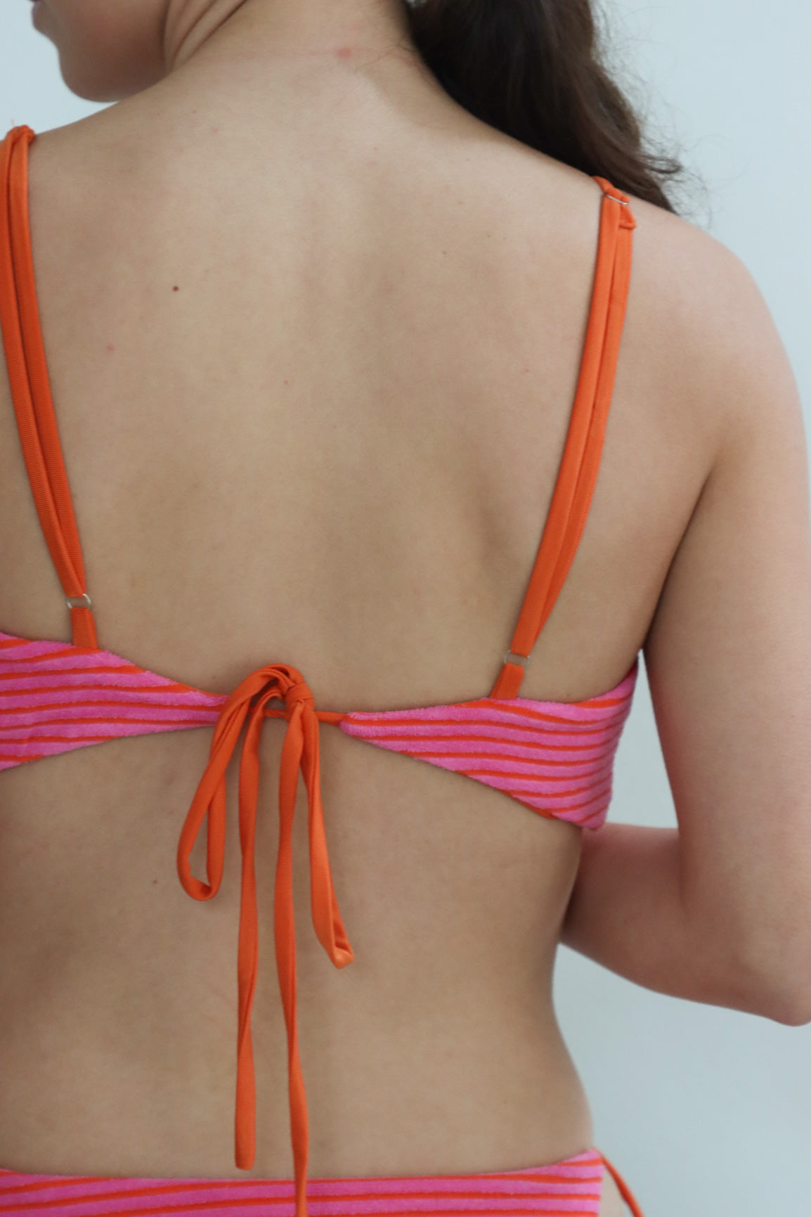 girl wearing hot pink terry cloth bikini