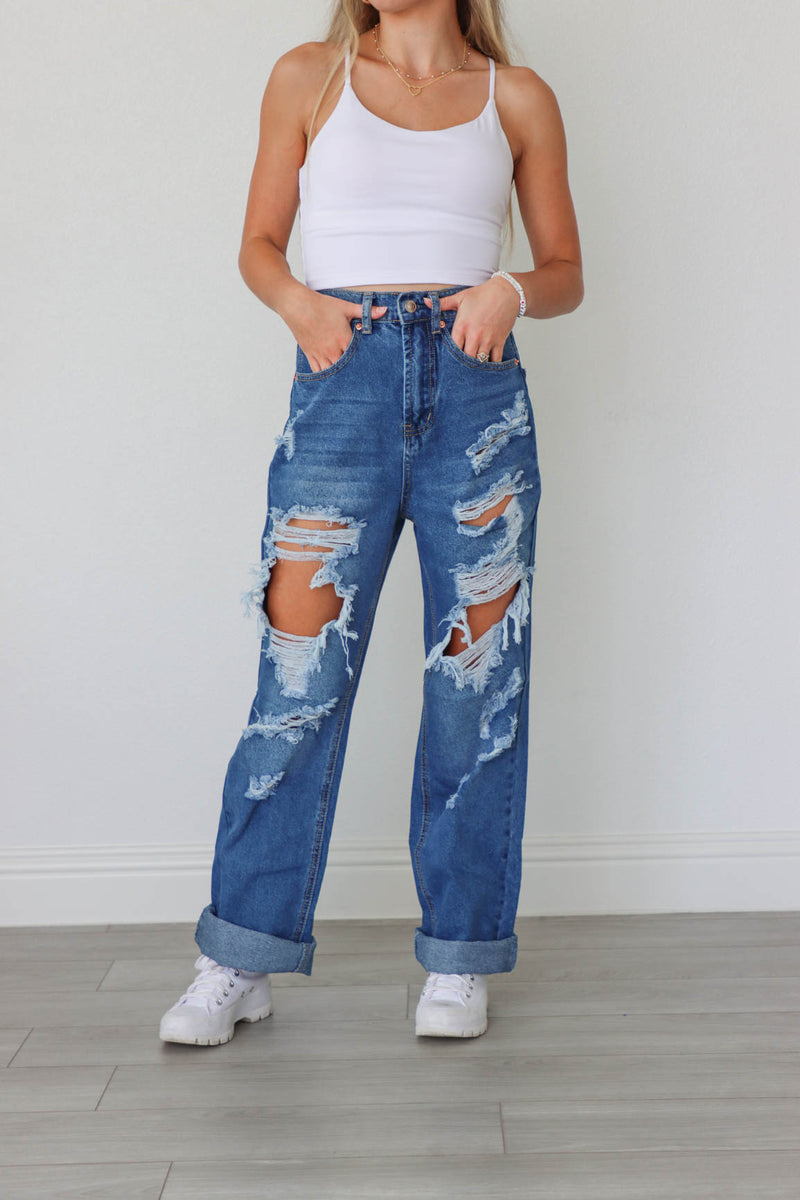 girl wearing medium wash ripped jeans