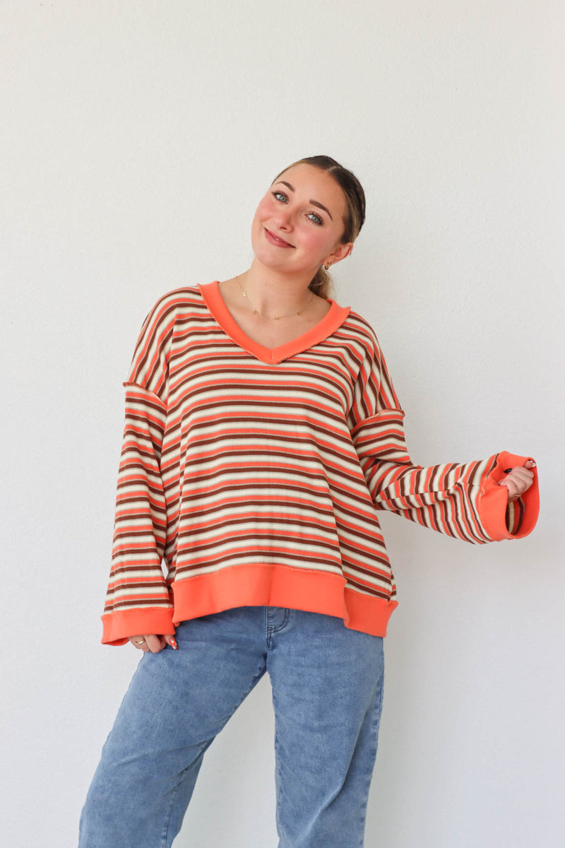 girl wearing orange striped top