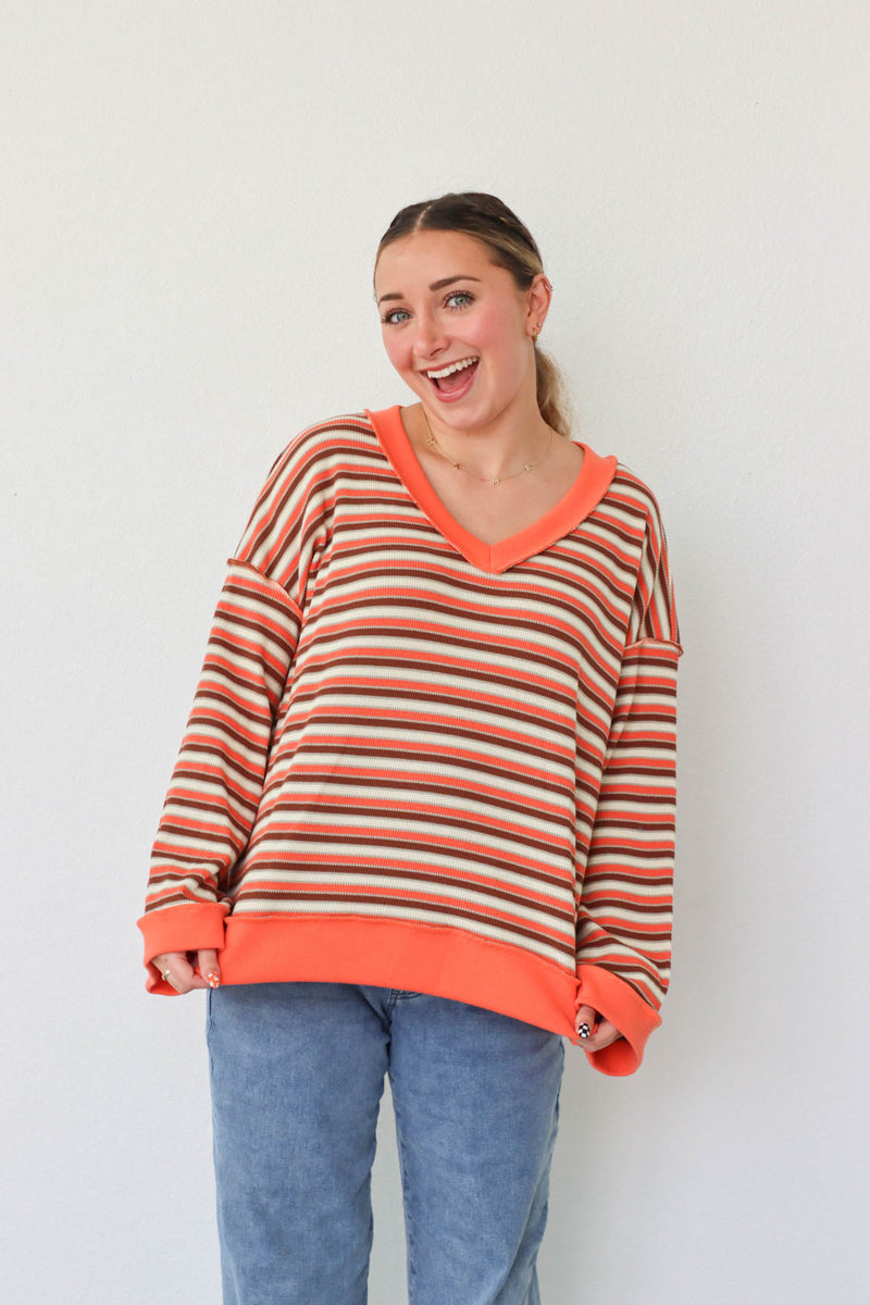 girl wearing orange striped top