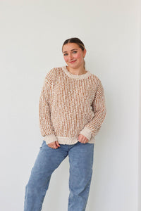 girl wearing tan and cream knit sweater