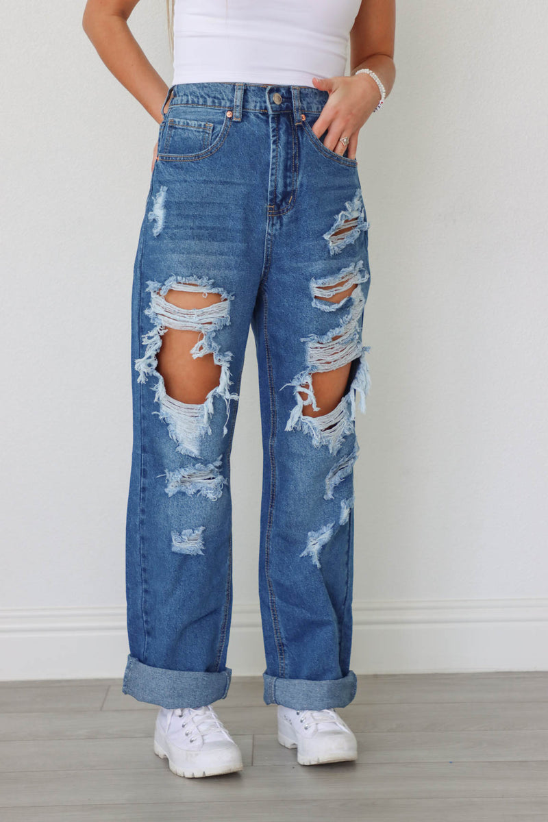 girl wearing medium wash ripped jeans
