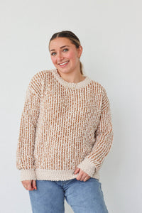 girl wearing tan and cream knit sweater