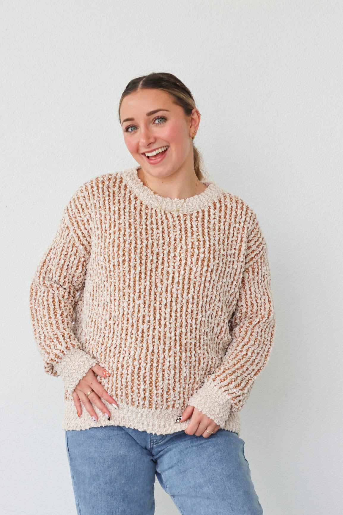 girl wearing tan and cream knit sweater