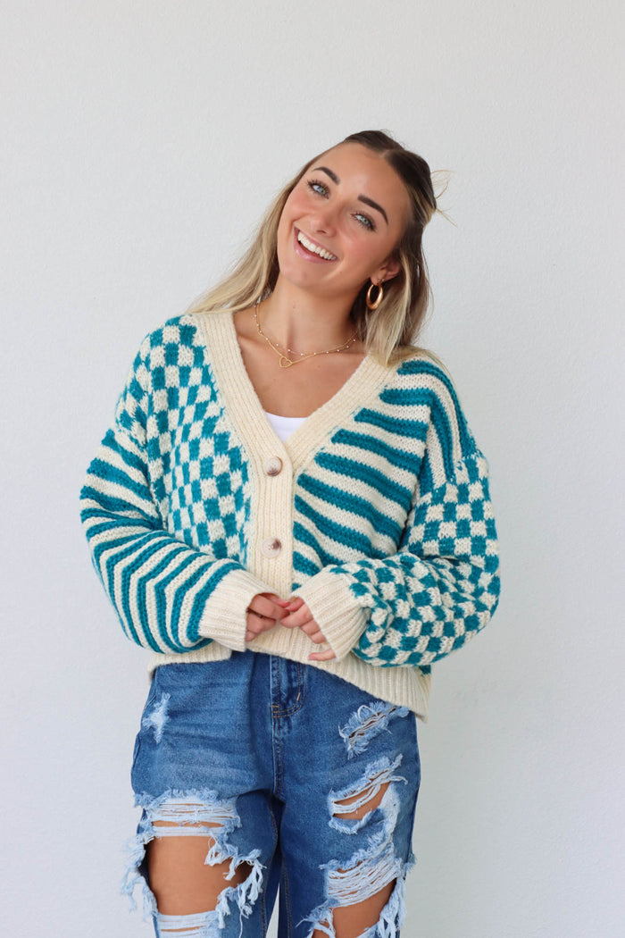 girl wearing teal and cream checkered print knit cardigan sweater