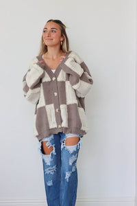 girl wearing brown and cream checkered print fuzzy cardigan