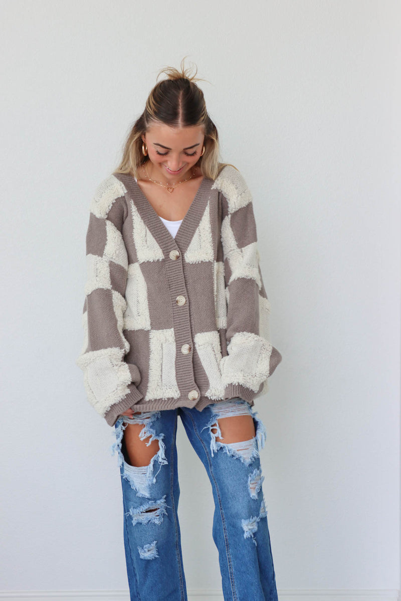girl wearing brown and cream checkered print fuzzy cardigan
