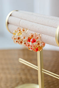 red and yellow resin floral hoop earrings