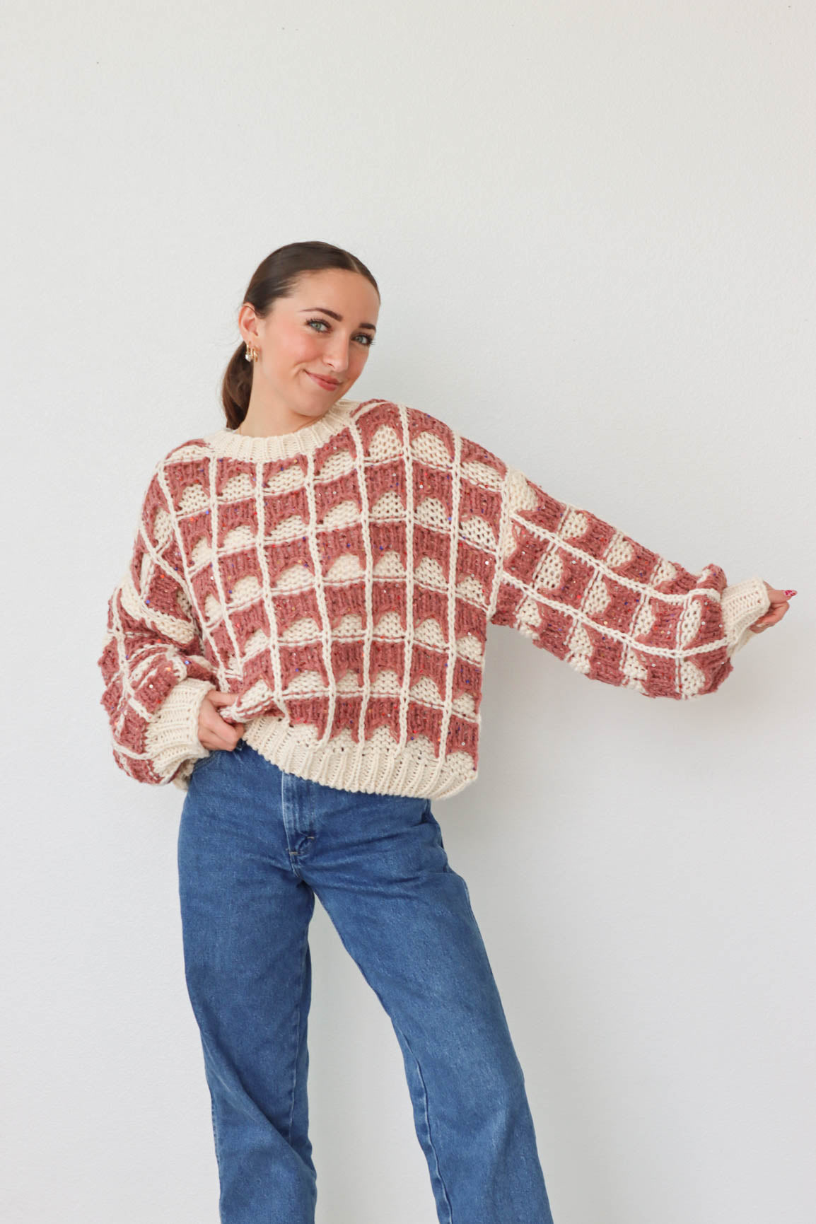 girl wearing mauve and cream knit sweater