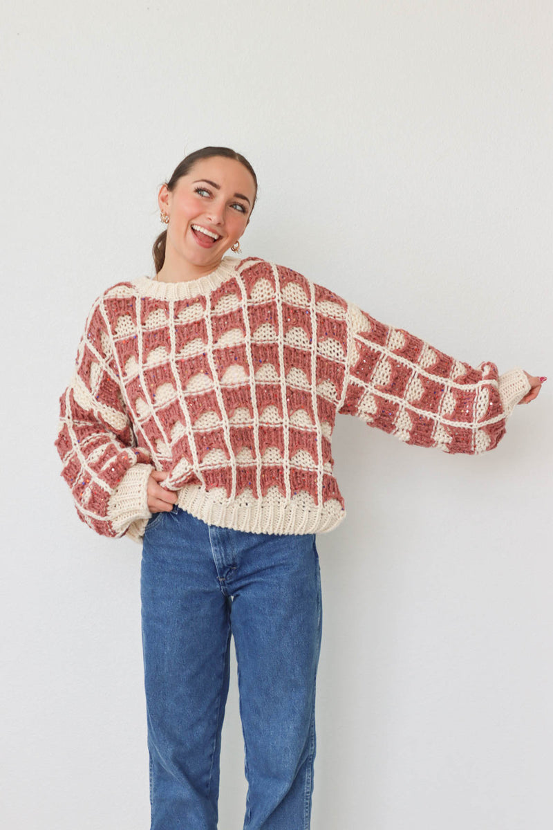 girl wearing mauve and cream knit sweater