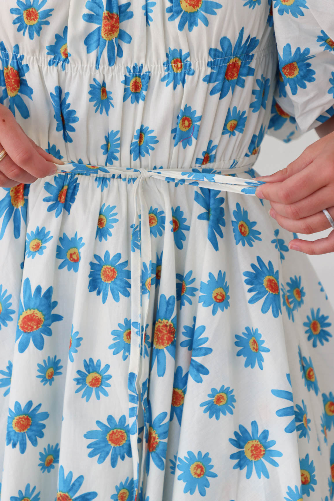 waist tie on white puff sleeved dress with blue florals 