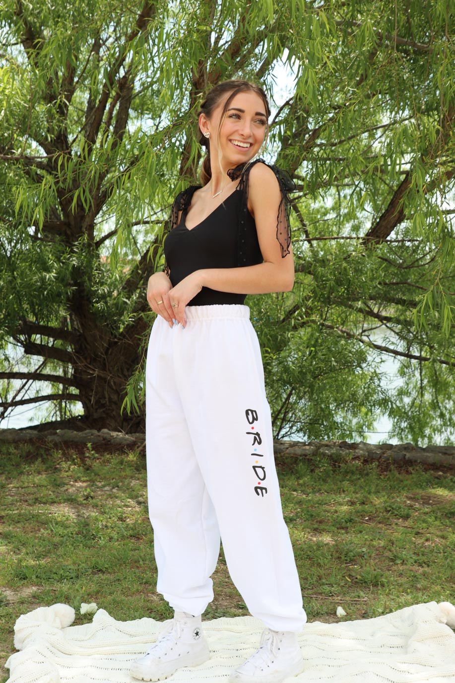 girl wearing white sweatpants with "bride" letter detailing