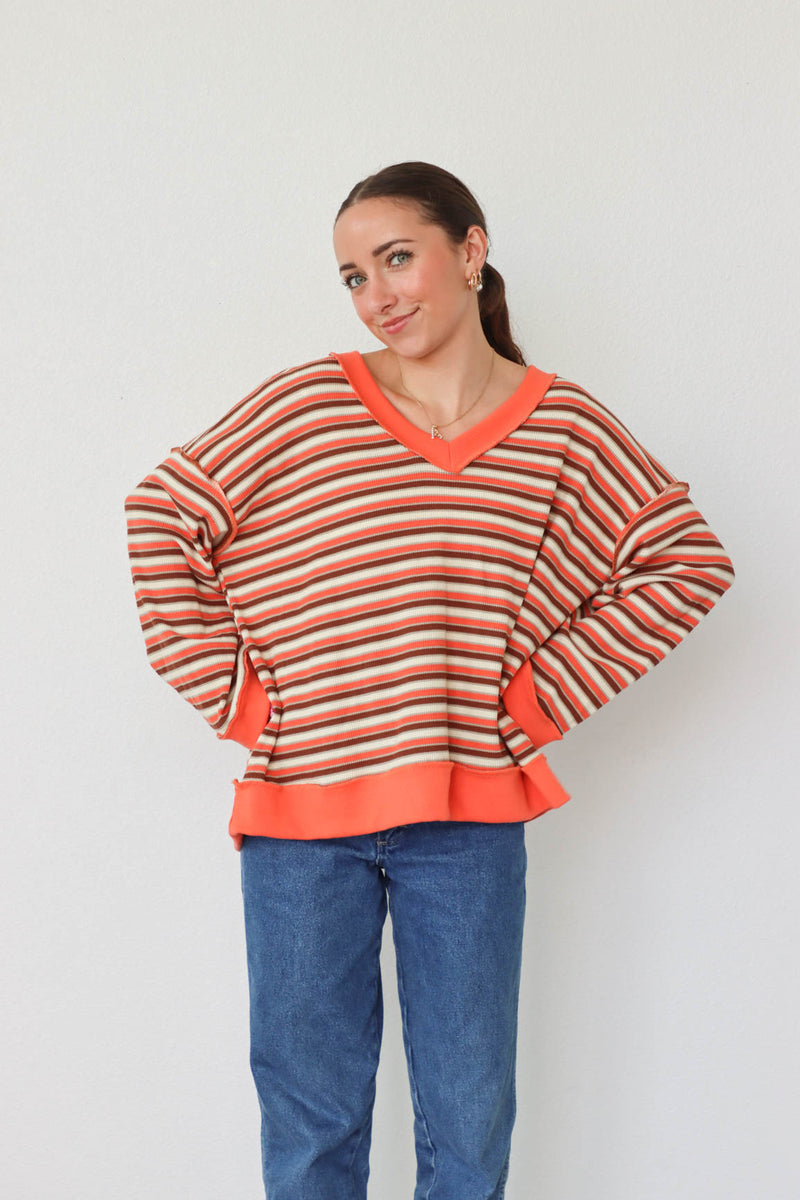 girl wearing orange striped top