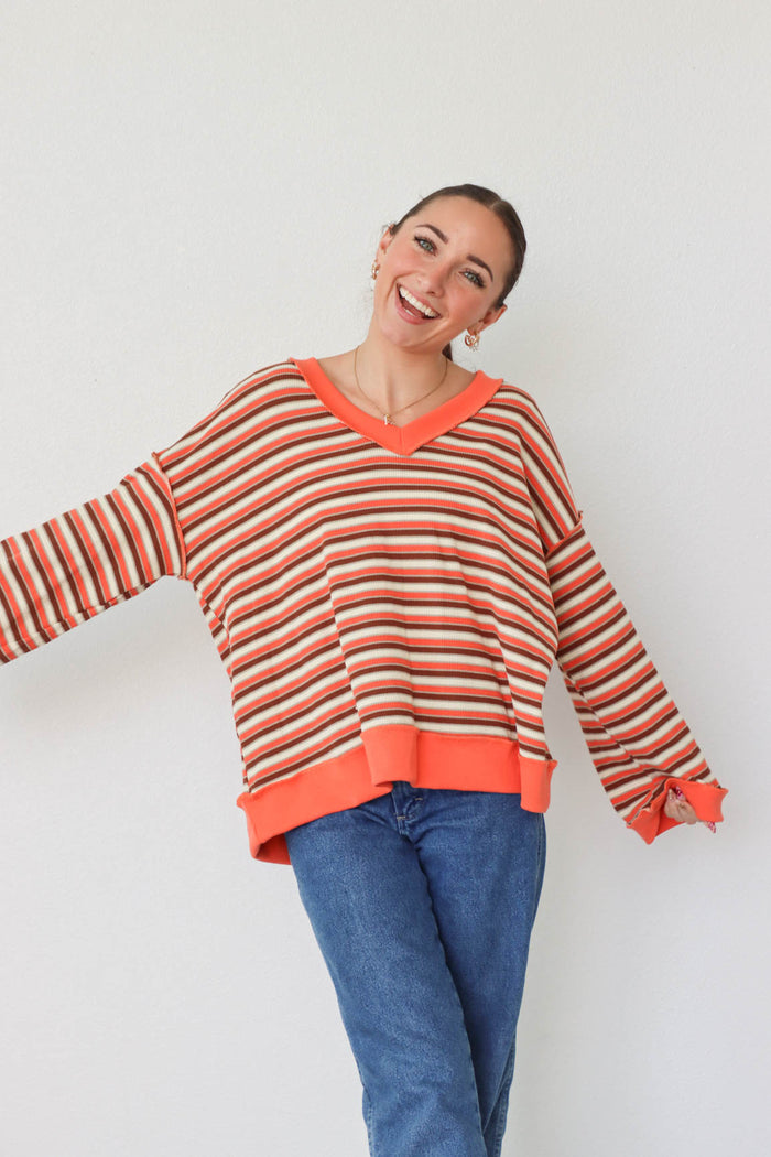 girl wearing orange striped top