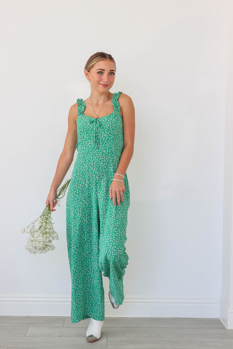 girl wearing green floral jumpsuit