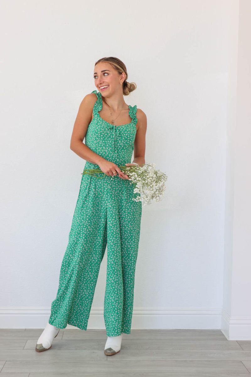 girl wearing green floral jumpsuit