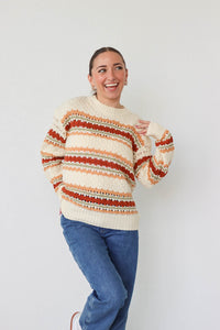 girl wearing cream multicolored knit sweater