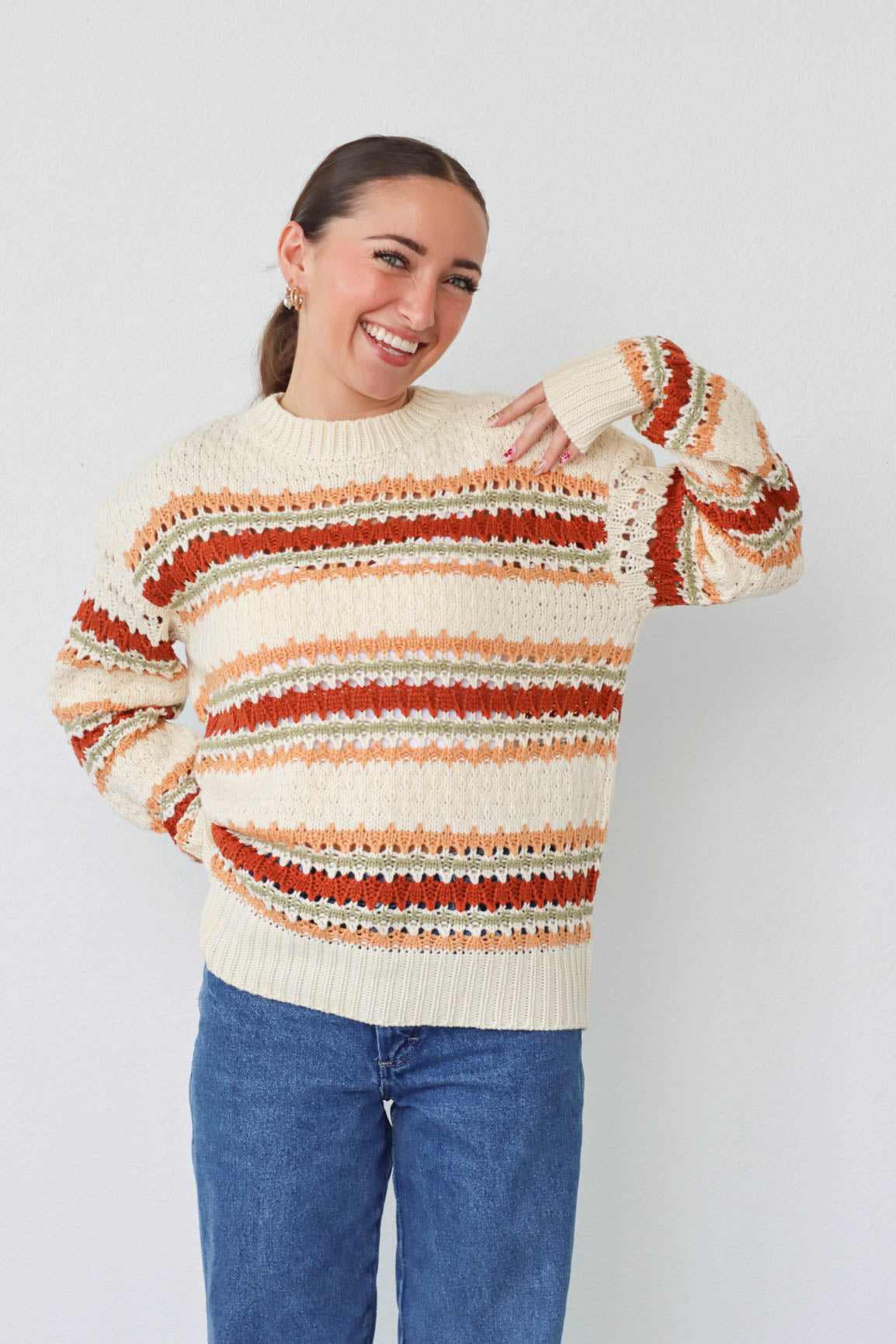 girl wearing cream multicolored knit sweater