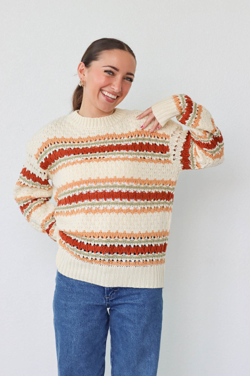 girl wearing cream multicolored knit sweater