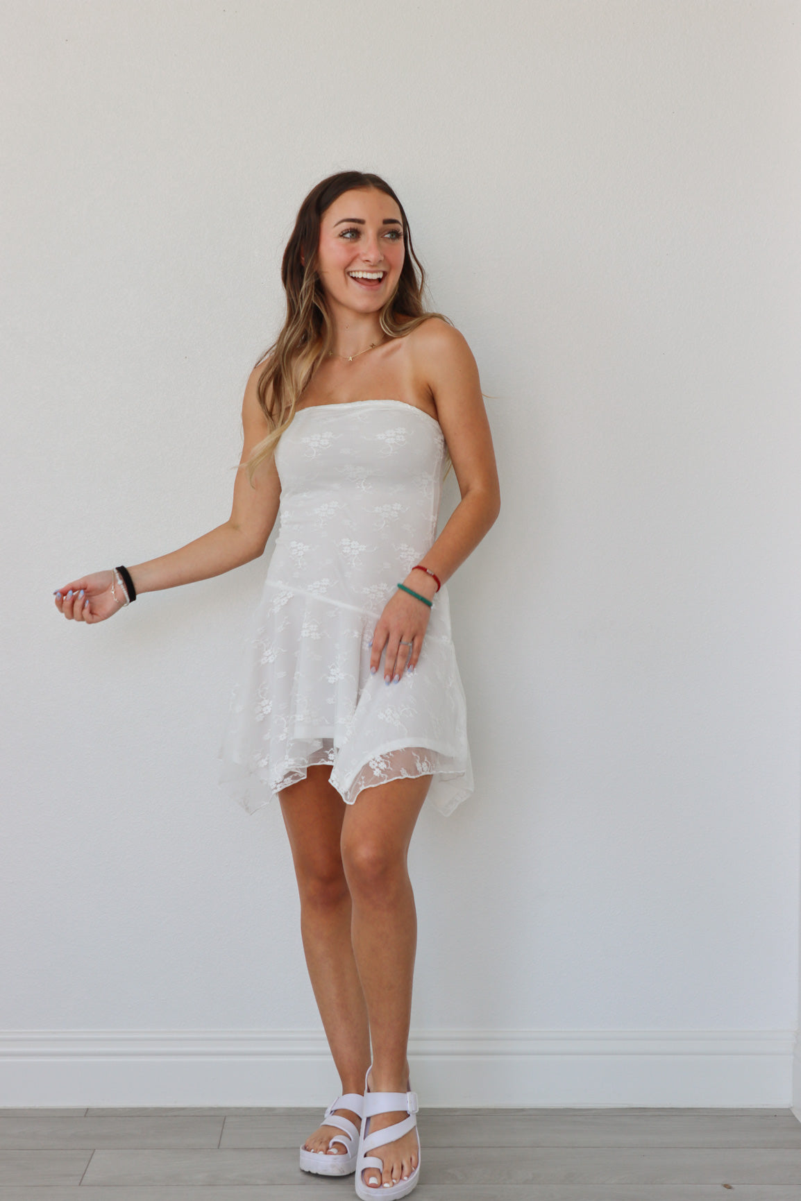 girl wearing white tube top lace dress