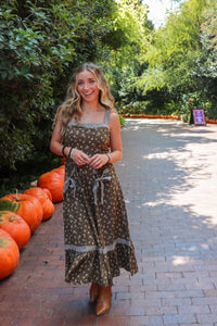 woman wearing brown floral maxi dress