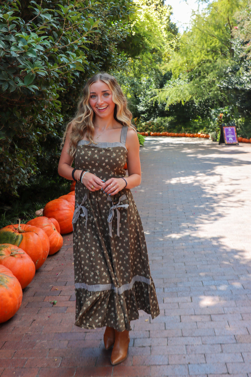 woman wearing brown floral maxi dress