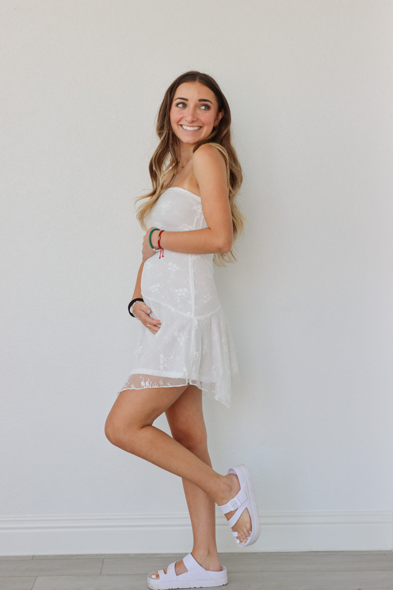 girl wearing white tube top lace dress