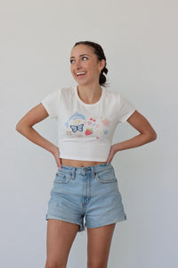 girl wearing white cropped graphic tee shirt