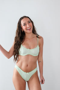 girl wearing mint green gingham bikini