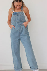 girl wearing light wash denim overalls