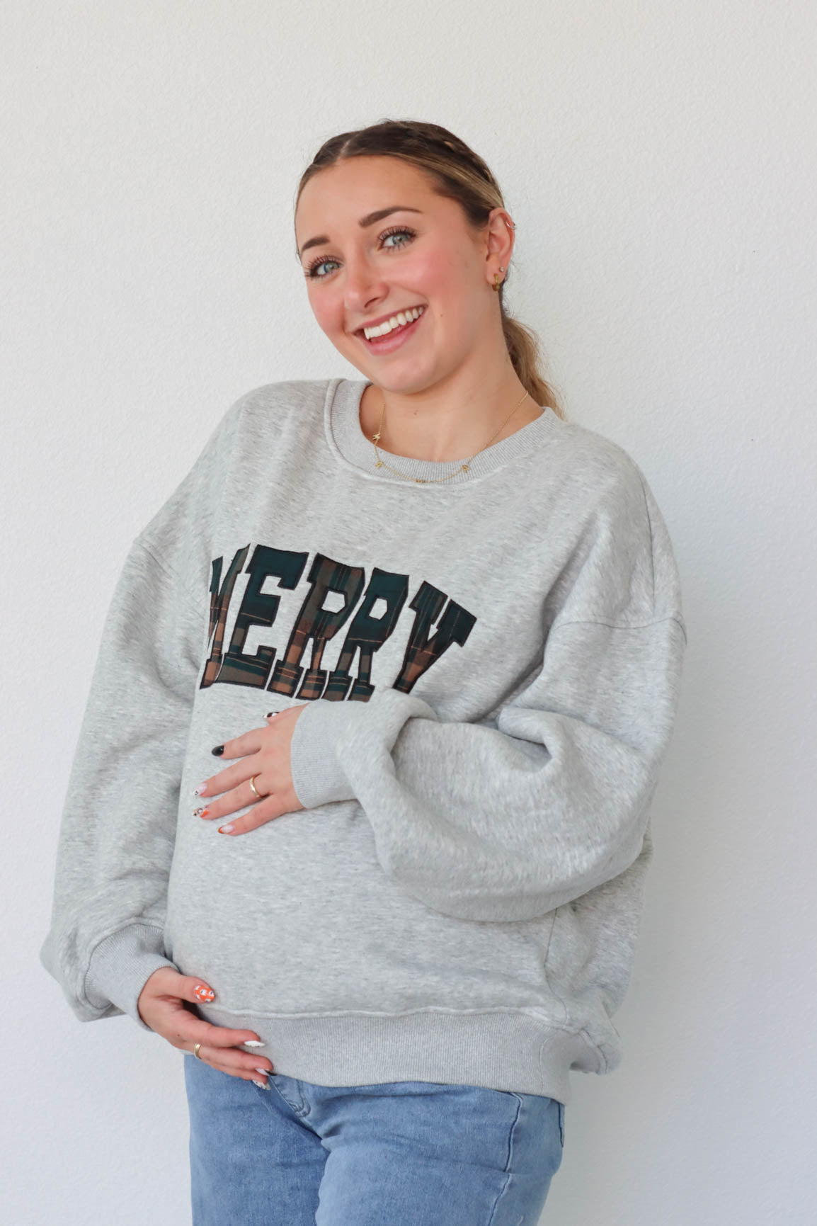 girl wearing light gray merry crewneck