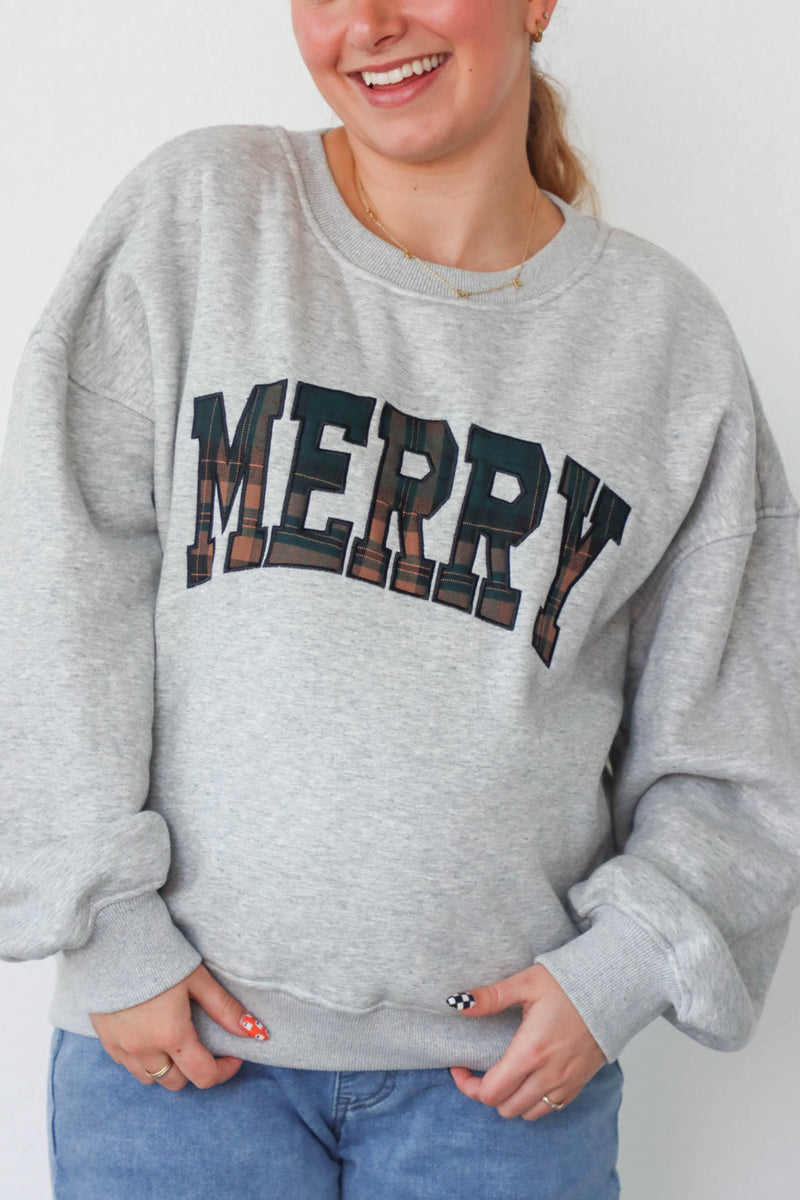 girl wearing light gray merry crewneck