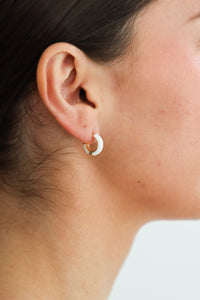 girl wearing white hoop earrings