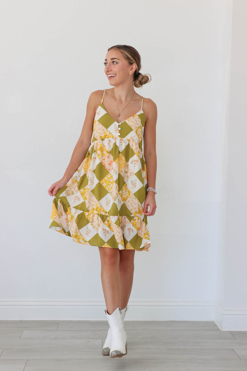 girl wearing green and yellow patterned short dress