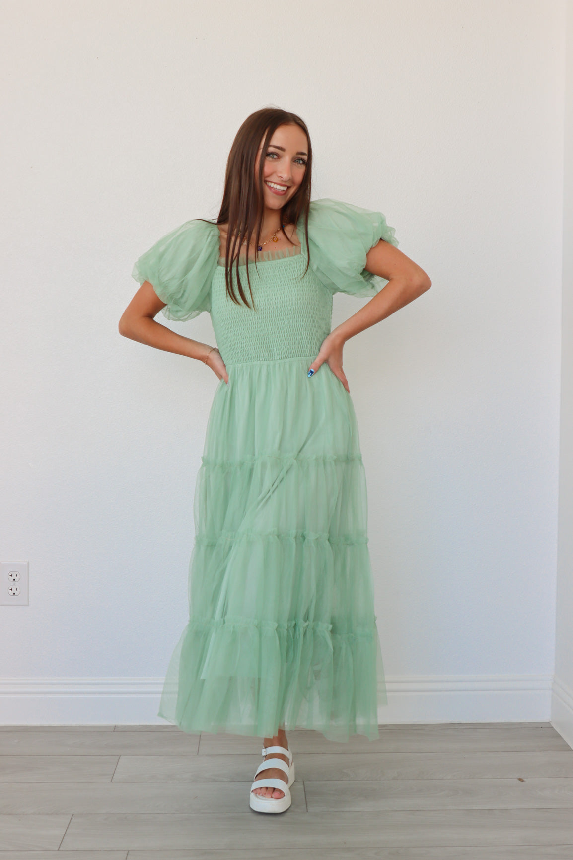 girl wearing mint long dress with tulle detailing