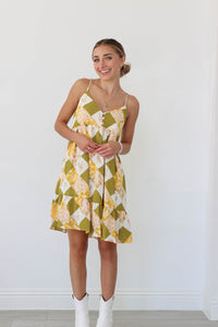 girl wearing green and yellow patterned short dress