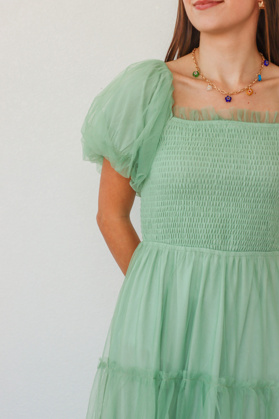 girl wearing mint long dress with tulle detailing