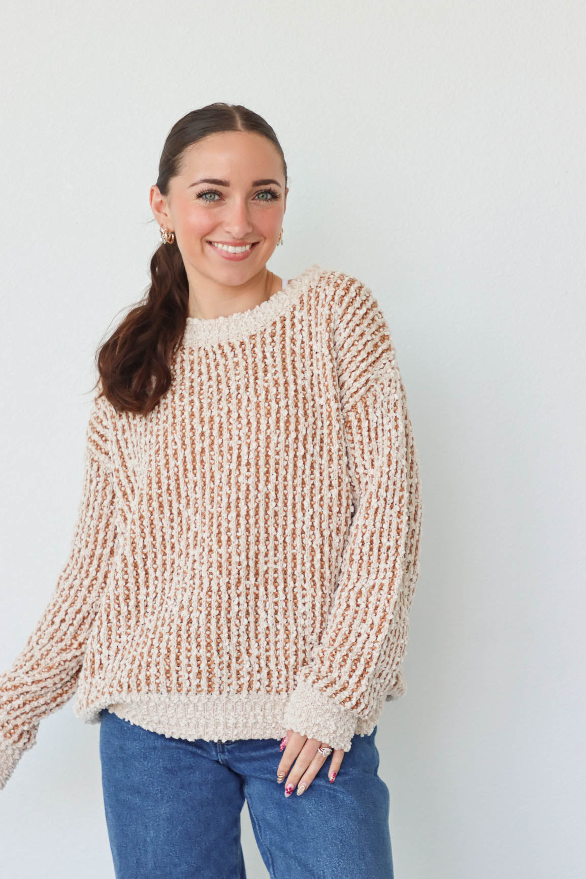 girl wearing tan and cream knit sweater