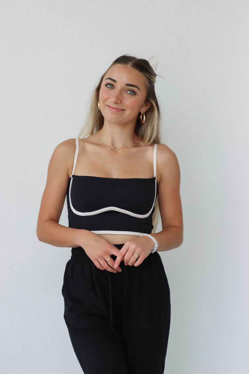 girl wearing black and white cropped athletic tank top
