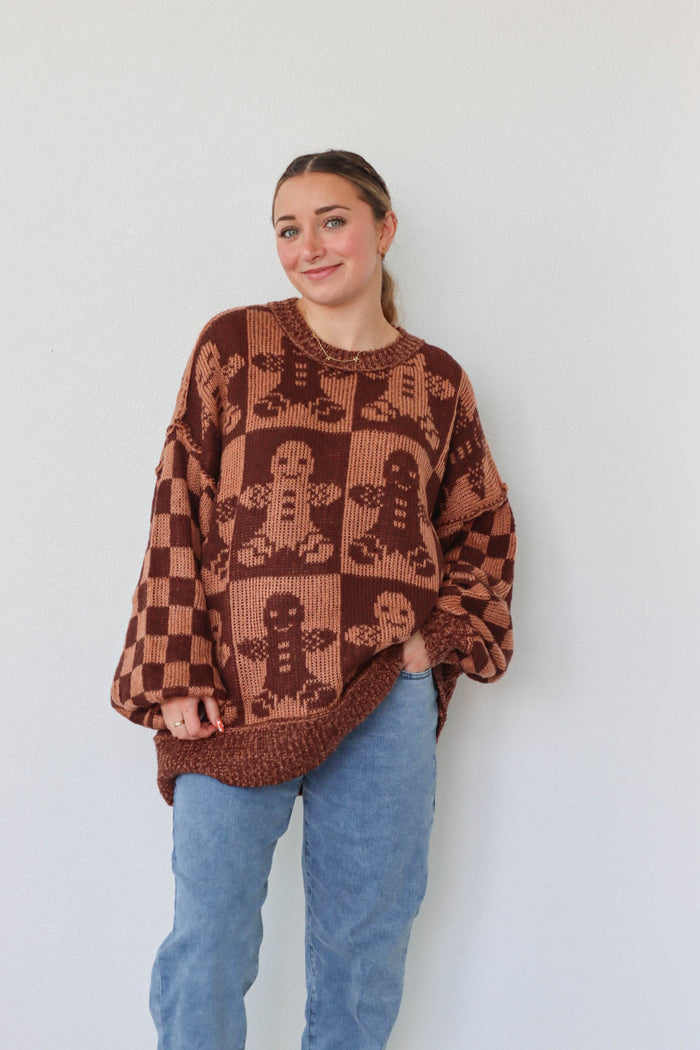 girl wearing brown gingerbread sweater