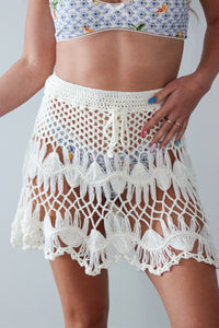 girl wearing cream cover up skirt