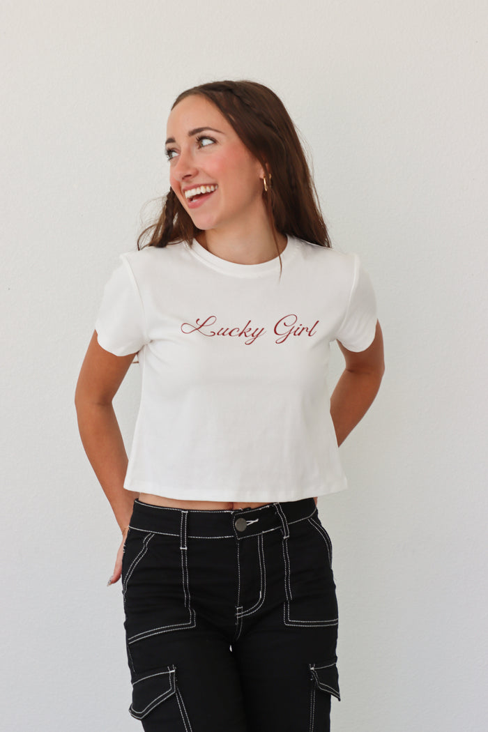 girl wearing white "lucky girl" tee