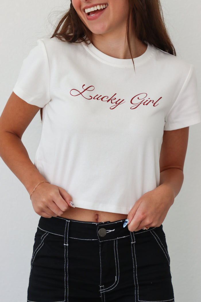 girl wearing white "lucky girl" tee