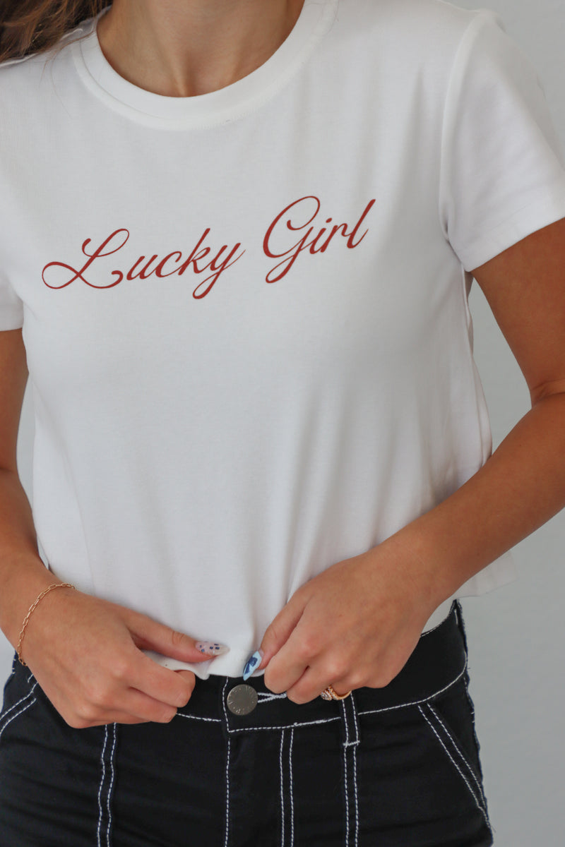 girl wearing white "lucky girl" tee