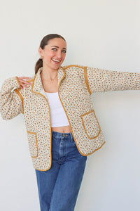 girl wearing cream quilted jacket