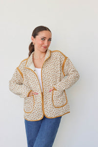 girl wearing cream quilted jacket