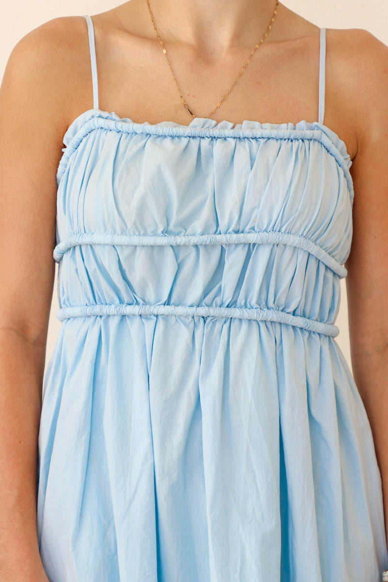 girl wearing light blue short dress