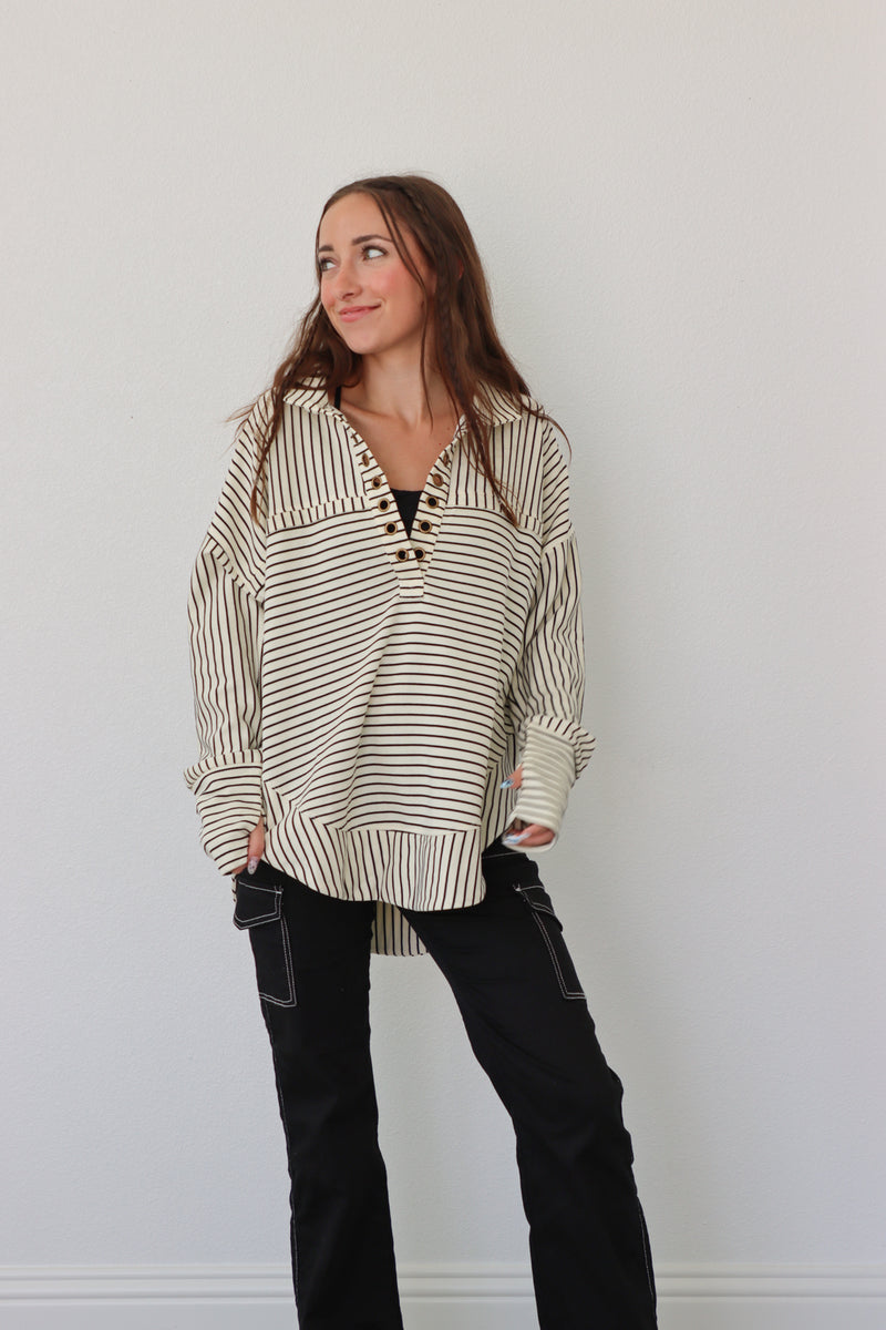 girl wearing cream pullover with black stripes